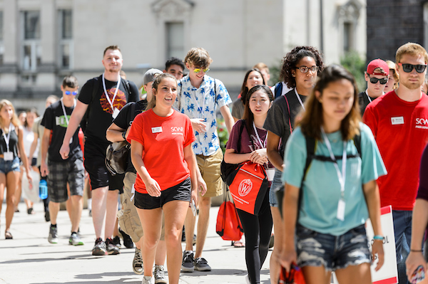 New-student leaders walk with incoming first-year undergraduates as the group heads to a Student Orientation, Advising and Registration (SOAR)