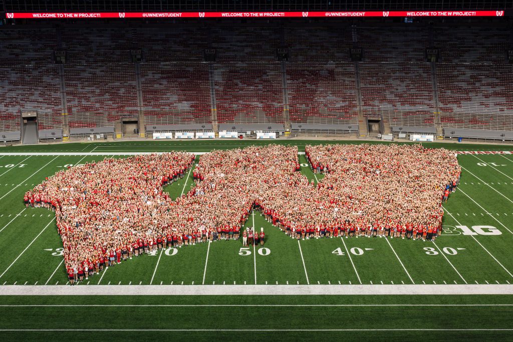First-year students, along with UW mascot Bucky Badger and Chancellor Mnookin form the shape of an iconic Motion W as part of the W Project.